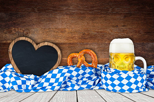 Beer Fest wood background Beer Fest background with beer mug bavarian flag and empty heart shaped blackboard large german beer steins stock pictures, royalty-free photos & images