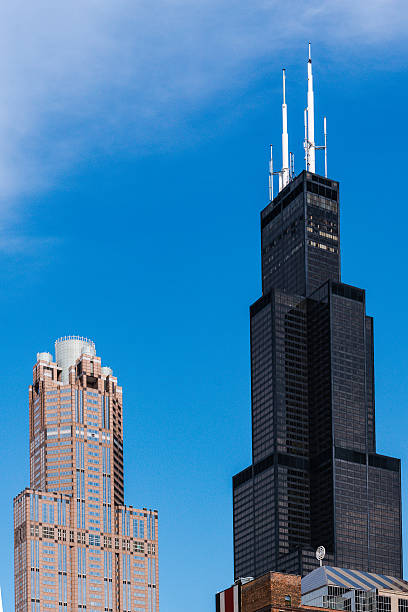 Willis Tower against Blue Sky A view of the Willis Tower against a bright blue sky willis tower stock pictures, royalty-free photos & images