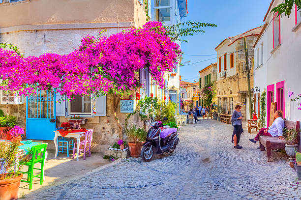 Historical Alacati Town in Turkey Alacati, Turkey - JUNE 07, 2014 : Undefined people are visiting Haci Memis Street in Alacati Town, Turkey. izmir photos stock pictures, royalty-free photos & images