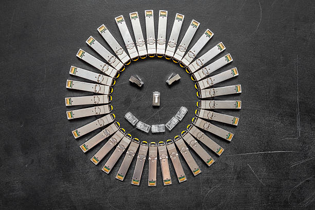 SFP network modules as the shape of face Electrical internet SFP network modules for network switch as the shape of face  with smile on the black background computer plan fiber optic engineer stock pictures, royalty-free photos & images