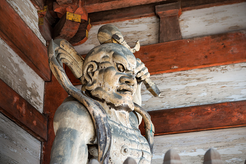 Kyoto, Japan - October 8, 2015: Close-up of the wooden guardian at the main gate of Ninna-ji temple in Kyoto, the head temple of the Omuro school of the Shingon Sect of Buddhism.