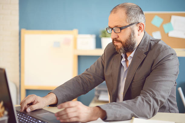istock Mature Adult man working in the office 588986586