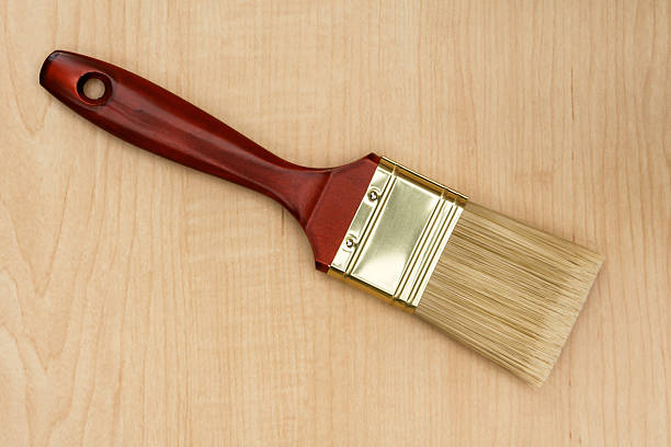 Wall paint brush on board stock photo