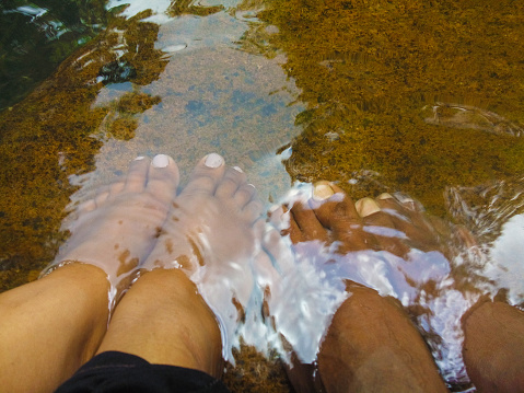 Feet in water stream