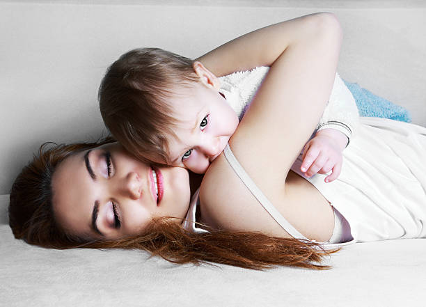 mother and baby at home stock photo