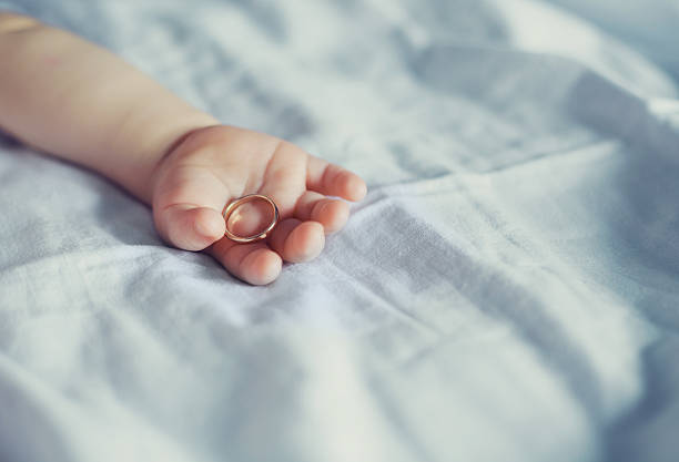 arm of a baby sleeping in bed at home
