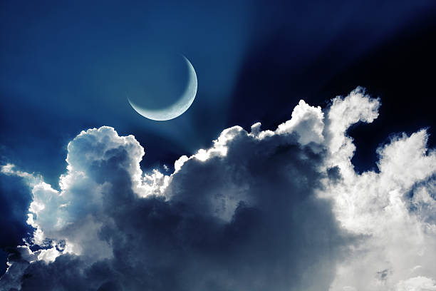 istock Crescent moon in a beautiful night sky with glowing clouds 588989070