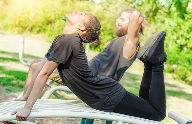 istock Young couple exercises gym outdoors 588989748