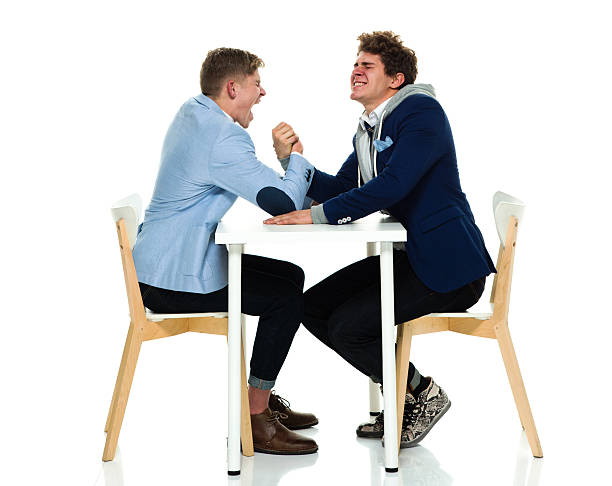 istock Brothers arm wrestling 588992780