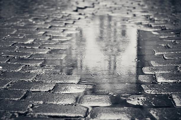Rainy day Rainy day. Reflection of the building in puddle on the city street during rain. puddle photos stock pictures, royalty-free photos & images