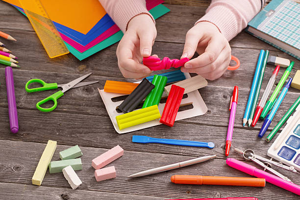 istock child hand with plasticine on wooden background 588993134