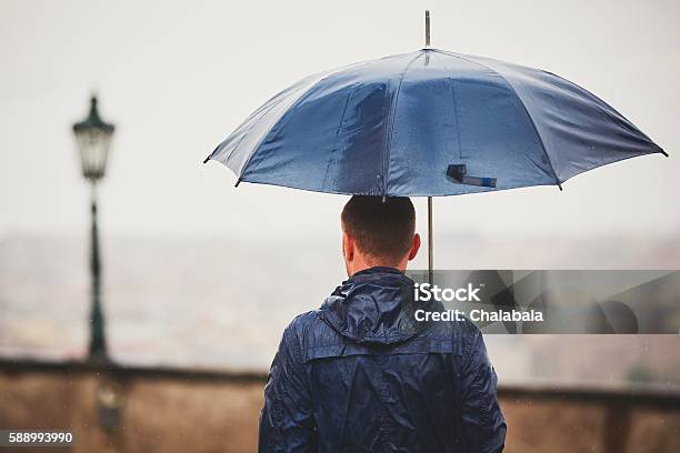 Man In Rain Stock Photo - Download Image Now - Umbrella, Blue, Leaving