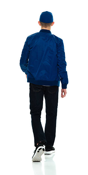 istock Rear view of male walking 588994664