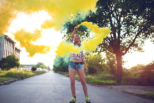 istock Girl using Colored smoke grenades outdoors 588997952