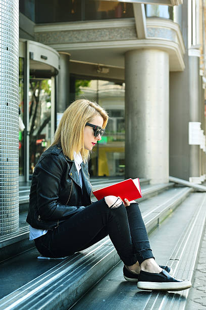istock hipster girl sitting on stairs 588998528