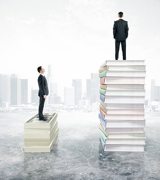 istock Handsome businessman standing on stack of books 588999696