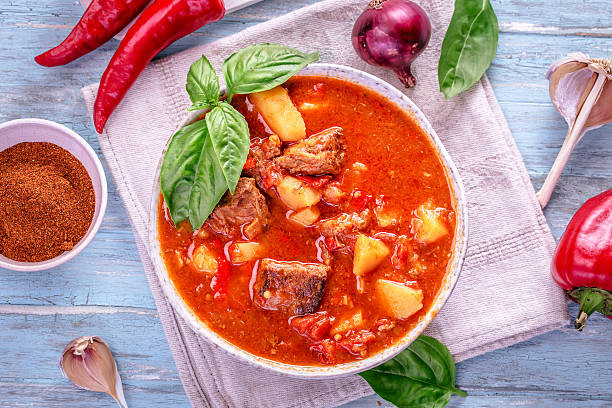 istock Hungarian goulash top view on cyan background 589001196