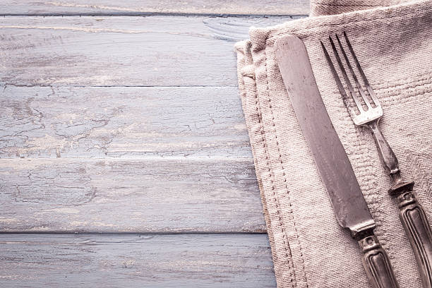 istock Vintage fork and knife on old wooden background 589001276