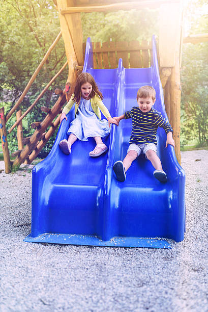 istock Kids on Slide on Public Playground 589088112