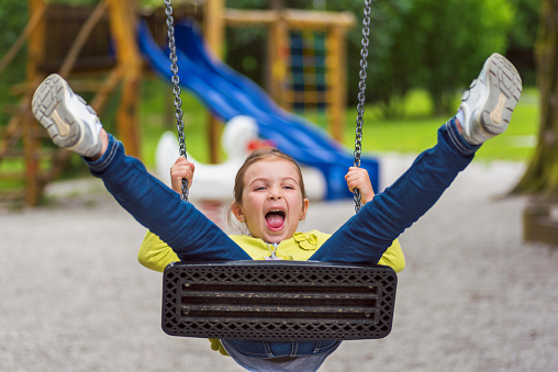 Cute Girl on Swing on Playground