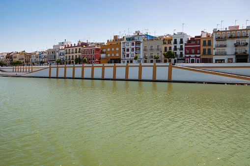 View of Betis street in Triana district of Seville from the Guadaquivir river, Spain