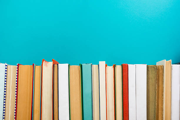 istock Books on grunge wooden table desk shelf in library. Back 589091376