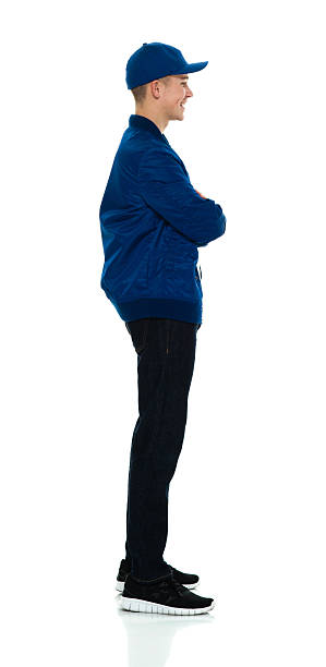 istock Smiling male standing with arms crossed 589092022