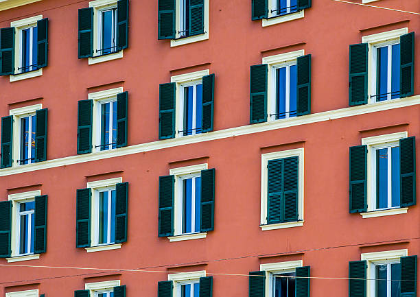 istock Green Shutters on Terracotta Orange Building 589093552