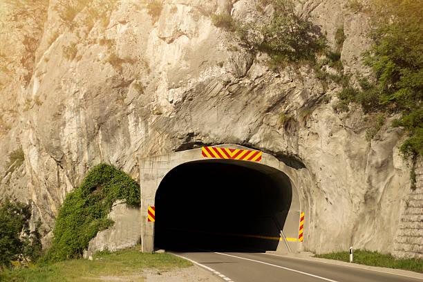 Road with tunnel and sunlight Road with tunnel and sunlight single yellow line sunlight usa utah stock pictures, royalty-free photos & images