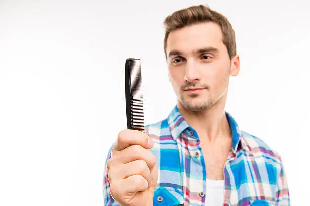 Photo of Handsome man holding a comb