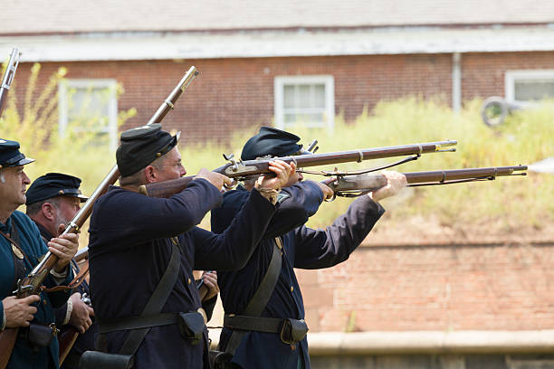 Civil War enactment New York, NY USA _ August 13, 2016: Members of 119th New York Volunteer Infantry  living history organization put on Civil War musket demonstrations at National Park Service annual Civil War heritage weekend at Governors Island civil war enactment stock pictures, royalty-free photos & images