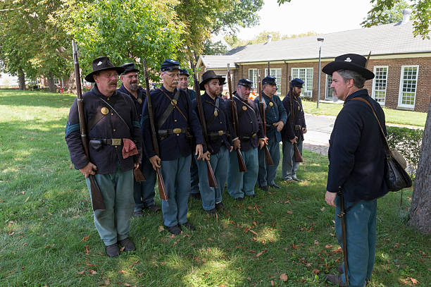 Civil War enactment New York, NY USA _ August 13, 2016: Members of 119th New York Volunteer Infantry  living history organization put on Civil War musket demonstrations at National Park Service annual Civil War heritage weekend at Governors Island civil war enactment stock pictures, royalty-free photos & images