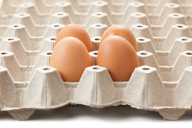 istock Close up of 4 eggs on rag. or cartons packing. 589098400