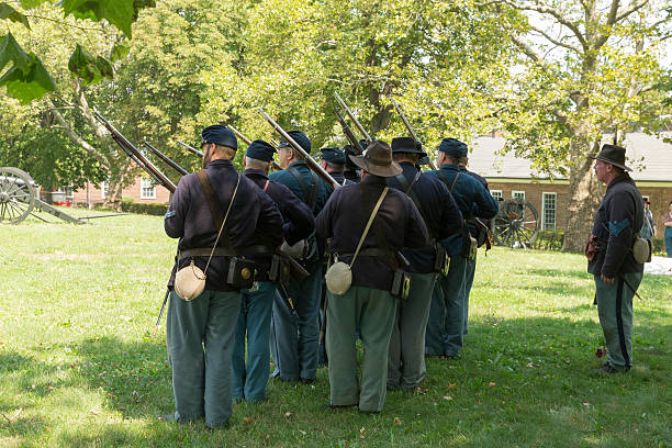 Civil War enactment New York, NY USA - August 13, 2016: Members of 119th New York Volunteer Infantry  living history organization put on Civil War musket demonstrations at National Park Service annual Civil War heritage weekend at Governors Island civil war enactment stock pictures, royalty-free photos & images