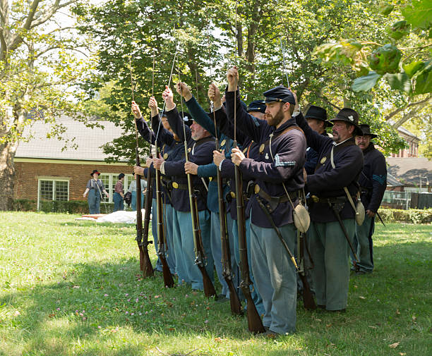 Civil War enactment New York, NY USA - August 13, 2016: Members of 119th New York Volunteer Infantry  living history organization put on Civil War musket demonstrations at National Park Service annual Civil War heritage weekend at Governors Island civil war enactment stock pictures, royalty-free photos & images