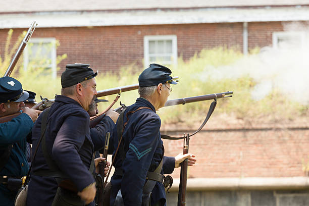 Civil War enactment New York, NY USA - August 13, 2016: Members of 119th New York Volunteer Infantry  living history organization put on Civil War musket demonstrations at National Park Service annual Civil War heritage weekend at Governors Island civil war enactment stock pictures, royalty-free photos & images