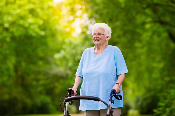 istock Senior lady with a walker in a sunny park 589098764