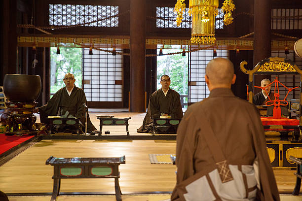 istock Three Japanese monks in prayer inside a Buddhist Temple 589100100