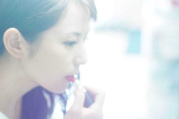 Woman applying lipstick