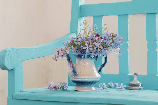 still life with spring flowers on blue bench