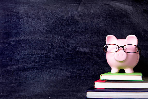 istock Piggybank with glasses and blackboard 589102420