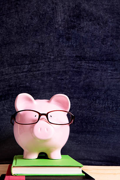 istock Piggybank with glasses and blackboard 589102490