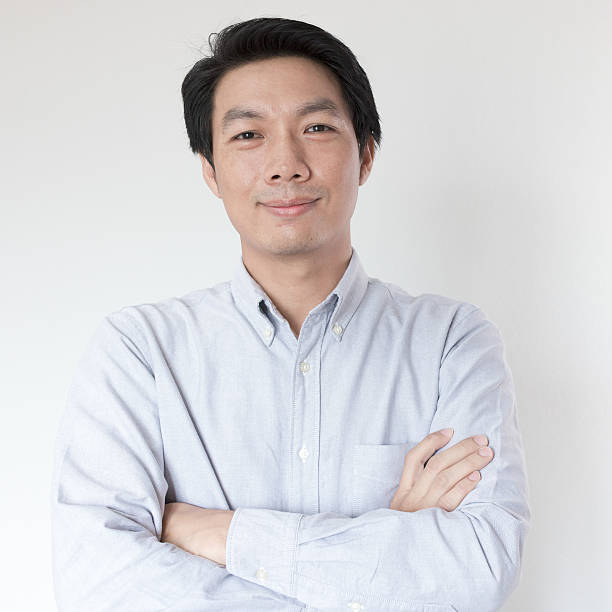 istock Young Asian man smiling on white background 589103334