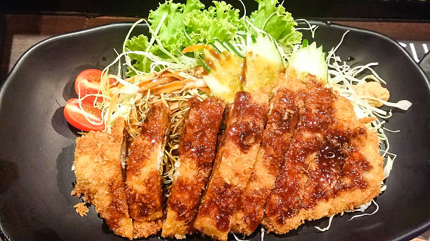 istock crispy fried pork and vegetable with sauce in black plate 589105650