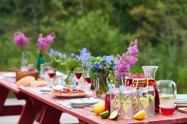 Holiday outdoors Festive table with food, drinks and flowers garden parties stock pictures, royalty-free photos & images