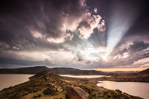 A horizontal composition of a dramatic sunset after a thunderstorm over the Gariep dam in South Africa, near the town of Norvalspont, bordering the Free State and Eastern Cape provinces. The dam is used for irrigation, domestic leisure, and industrial purposes, as well as for power generation.