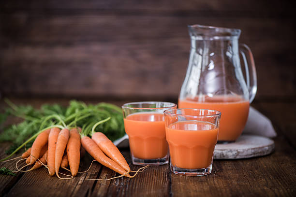 istock fresh carrot juice in jar and glasses 589110662