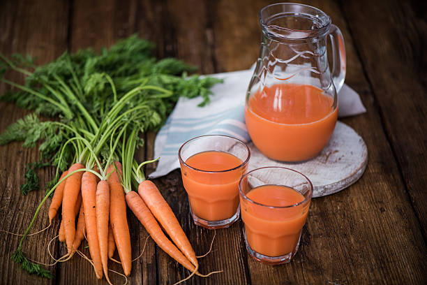 istock fresh carrot juice in jar and glasses 589110752