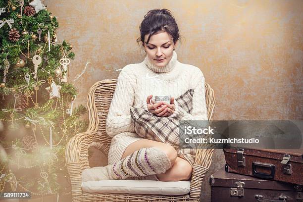 Beautiful Woman Drinking Tea Or Coffee Sitting In A Chair Stock Photo - Download Image Now