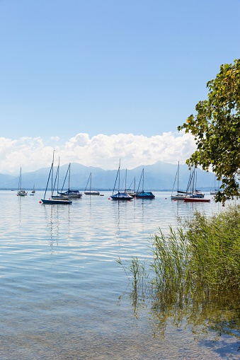 Lake Chiemsee, Bavaria, Germany - August 7th, 2016. Several sailing boats in Lake Chiemsee. Behind the Bavarian Alps.